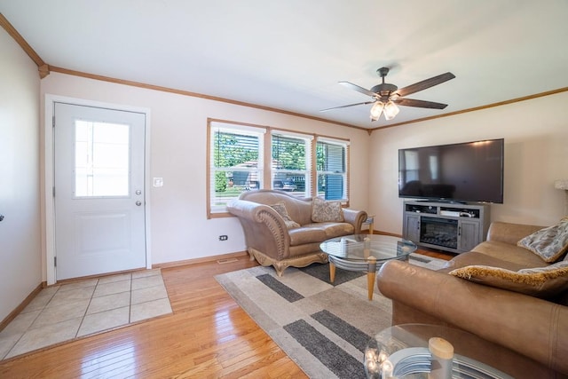 712 Mchenry Ave, Mchenry, IL 60050 - living room featuring crown molding, light wood-style flooring, ceiling fan, and a glass covered fireplace