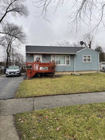 2637 Yeoman St, Waukegan, IL 60087 - view of front facade with a wooden deck, a front yard, and asphalt driveway