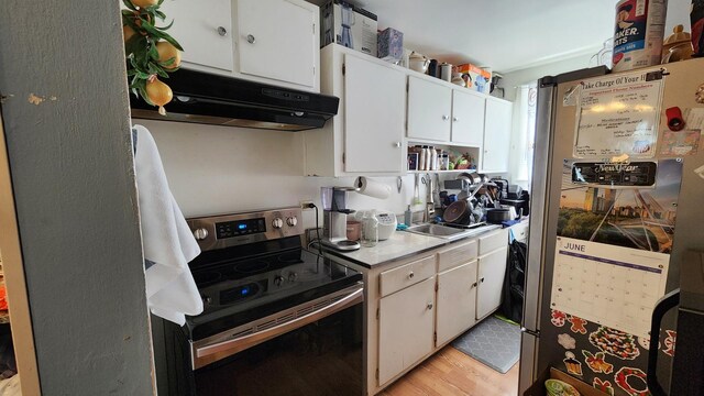 2637 Yeoman St, Waukegan, IL 60087 - kitchen featuring appliances with stainless steel finishes, under cabinet range hood, white cabinetry, light wood finished floors, and light countertops