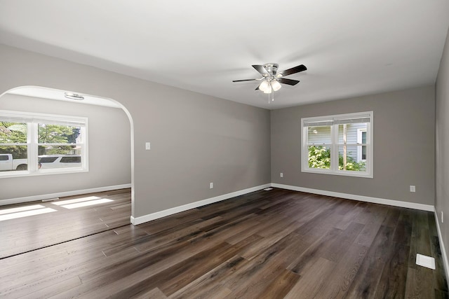 214 S Hickory St, Manteno, IL 60950 - unfurnished room featuring ceiling fan, dark wood-style flooring, and arched walkways