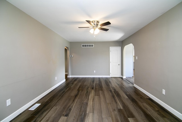 214 S Hickory St, Manteno, IL 60950 - unfurnished room featuring arched walkways, a ceiling fan, and dark wood-style floors