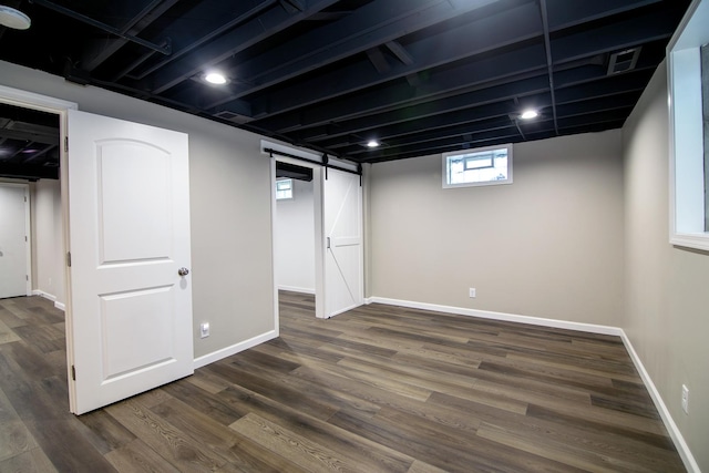 214 S Hickory St, Manteno, IL 60950 - below grade area with a barn door and dark wood-style floors
