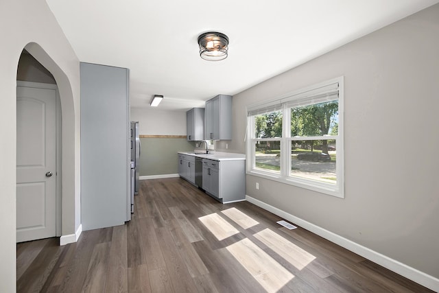214 S Hickory St, Manteno, IL 60950 - kitchen with gray cabinetry, appliances with stainless steel finishes, light countertops, and dark wood-type flooring