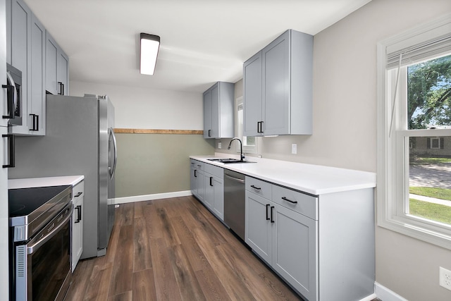 214 S Hickory St, Manteno, IL 60950 - kitchen with stainless steel appliances, gray cabinetry, dark wood-style flooring, and light countertops