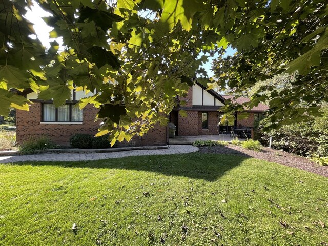 13745 S King Rd, Homer Glen, IL 60491 - view of front of house with brick siding, a front yard, and a patio