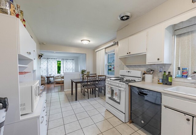 5124 W 32nd St, Cicero, IL 60804 - kitchen with white appliances, light tile patterned flooring, light countertops, and white cabinets