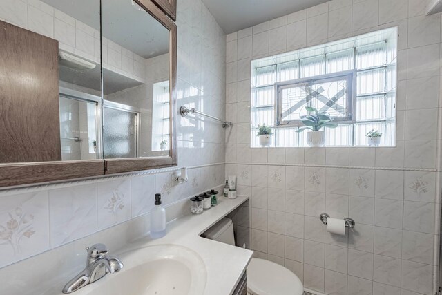 5124 W 32nd St, Cicero, IL 60804 - bathroom featuring an enclosed shower, vanity, and tile walls
