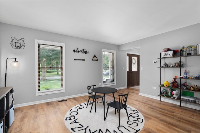 1297 Gregory Ct, Naperville, IL 60565 - dining area with healthy amount of natural light and light wood-style flooring