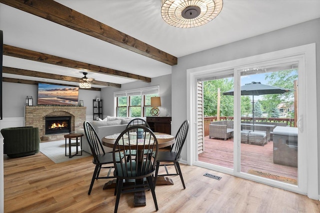 1297 Gregory Ct, Naperville, IL 60565 - dining area with light wood-style floors, ceiling fan, a fireplace, and beam ceiling