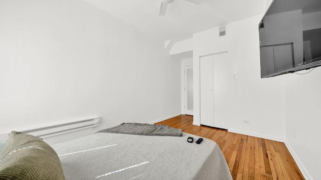 5150 S King Dr Unit A1, Chicago, IL 60615 - bedroom featuring wood finished floors, baseboard heating, and a ceiling fan