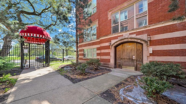 5150 S King Dr Unit A1, Chicago, IL 60615 - view of exterior entry with a gate and brick siding