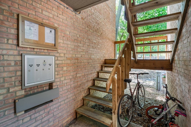 6021 Forest View Rd Unit 2C, Lisle, IL 60532 - staircase featuring brick wall and mail area