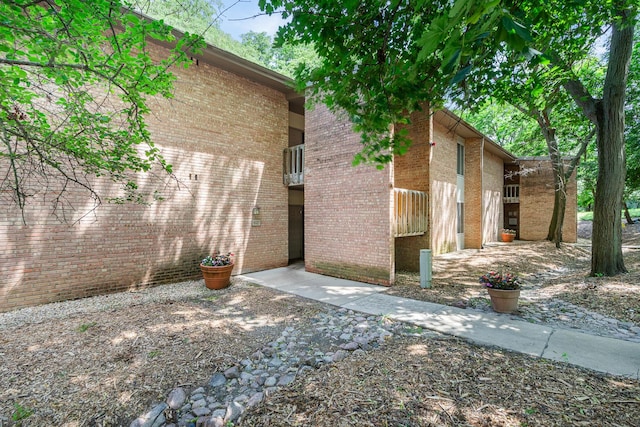 6021 Forest View Rd Unit 2C, Lisle, IL 60532 - view of property exterior with a balcony and brick siding