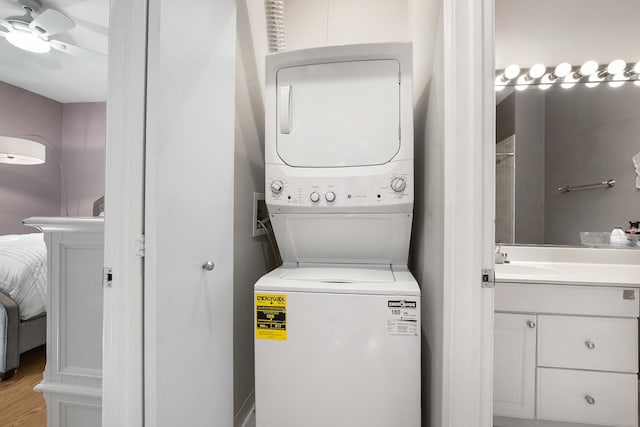 2809 N Wolcott Ave Unit H, Chicago, IL 60657 - washroom featuring stacked washer / drying machine, ceiling fan, and light wood-style flooring