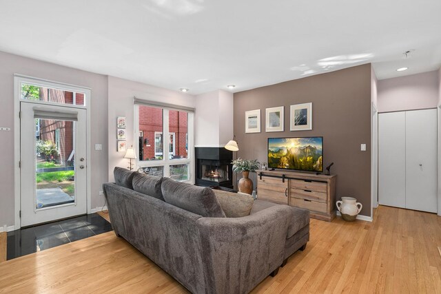 2809 N Wolcott Ave Unit H, Chicago, IL 60657 - living room with a lit fireplace, wood finished floors, and recessed lighting