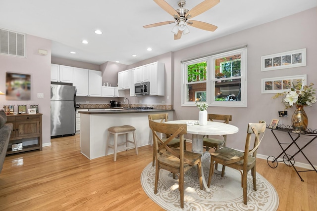 2809 N Wolcott Ave Unit H, Chicago, IL 60657 - dining room featuring light wood-type flooring, ceiling fan, and recessed lighting