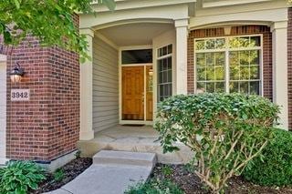 3942 Honeymoon Rdg, Lake In The Hills, IL 60156 - doorway to property with brick siding and covered porch
