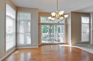3942 Honeymoon Rdg, Lake In The Hills, IL 60156 - unfurnished dining area with a chandelier and wood finished floors