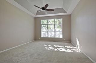 3942 Honeymoon Rdg, Lake In The Hills, IL 60156 - carpeted spare room featuring a tray ceiling and a ceiling fan