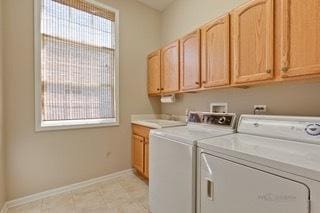 3942 Honeymoon Rdg, Lake In The Hills, IL 60156 - washroom with washer and clothes dryer and cabinet space
