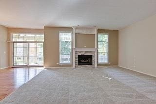 3942 Honeymoon Rdg, Lake In The Hills, IL 60156 - unfurnished living room with a fireplace and carpet