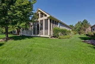 3942 Honeymoon Rdg, Lake In The Hills, IL 60156 - back of property featuring a lawn and a sunroom