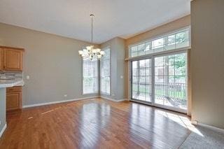 3942 Honeymoon Rdg, Lake In The Hills, IL 60156 - unfurnished dining area featuring a chandelier and wood finished floors