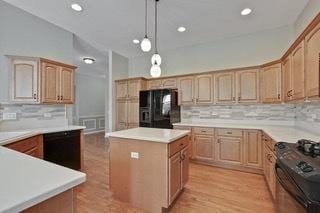 3942 Honeymoon Rdg, Lake In The Hills, IL 60156 - kitchen featuring black appliances, a center island, decorative backsplash, hanging light fixtures, and light countertops