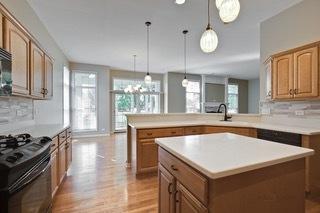 3942 Honeymoon Rdg, Lake In The Hills, IL 60156 - kitchen featuring range, a peninsula, backsplash, and light countertops