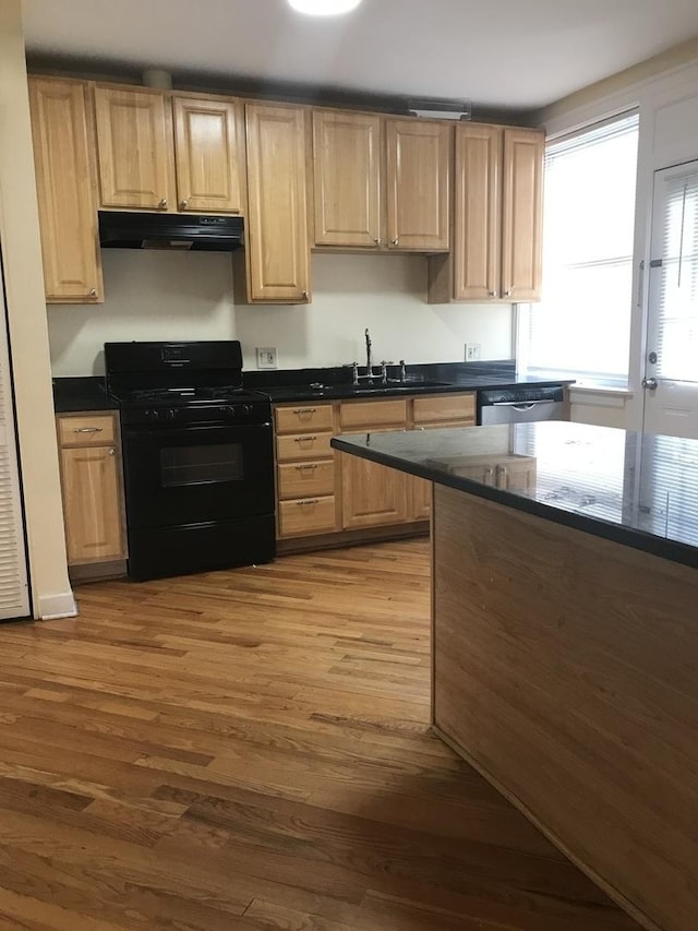 6457 N California Ave Unit 3, Chicago, IL 60645 - kitchen featuring black gas stove, extractor fan, wood finished floors, stainless steel dishwasher, and dark countertops