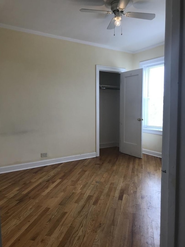 6457 N California Ave Unit 3, Chicago, IL 60645 - unfurnished bedroom featuring dark wood-style floors, crown molding, a closet, and a ceiling fan