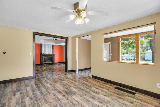 403 E Cooke St, Mount Pulaski, IL 62548 - unfurnished room with wood finished floors and ceiling fan