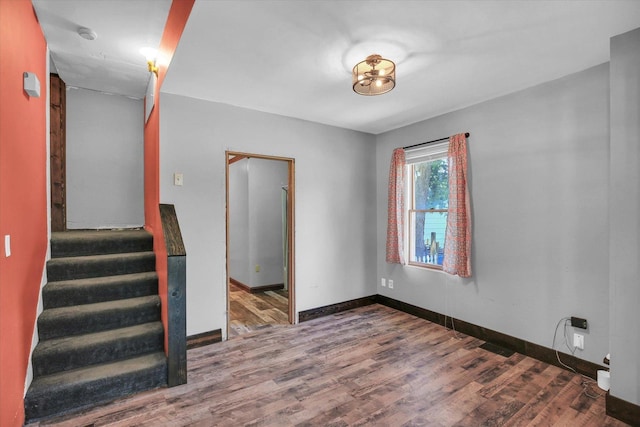 403 E Cooke St, Mount Pulaski, IL 62548 - unfurnished room with stairway and wood finished floors
