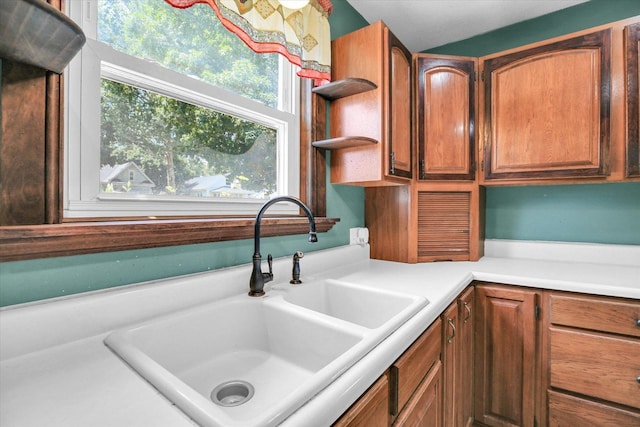 403 E Cooke St, Mount Pulaski, IL 62548 - kitchen featuring light countertops, open shelves, and brown cabinets