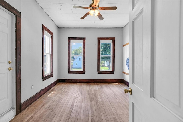 403 E Cooke St, Mount Pulaski, IL 62548 - spare room with healthy amount of natural light, hardwood / wood-style flooring, and a ceiling fan