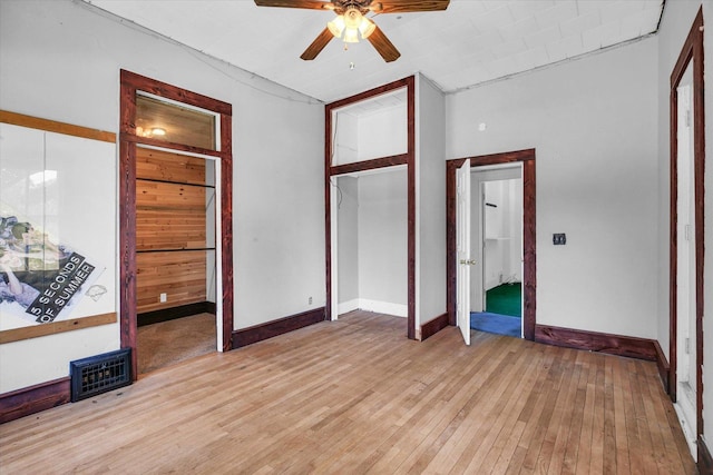 403 E Cooke St, Mount Pulaski, IL 62548 - unfurnished bedroom featuring light wood finished floors and ceiling fan