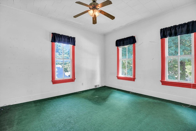 403 E Cooke St, Mount Pulaski, IL 62548 - spare room with dark colored carpet and ceiling fan