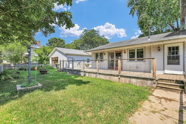 403 E Cooke St, Mount Pulaski, IL 62548 - rear view of property featuring an outdoor fire pit, a deck, and an outdoor structure