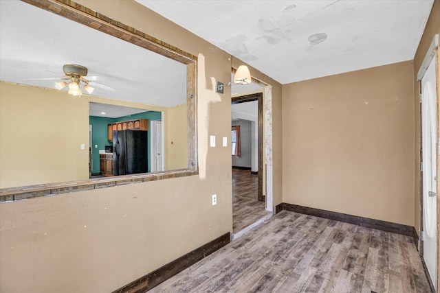 403 E Cooke St, Mount Pulaski, IL 62548 - spare room featuring wood finished floors and ceiling fan
