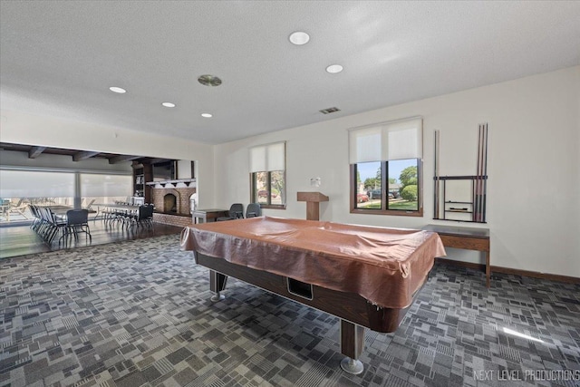 1050 N Farnsworth Ave Unit 202, Aurora, IL 60505 - rec room featuring carpet flooring, recessed lighting, billiards, a brick fireplace, and a textured ceiling