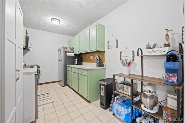 1050 N Farnsworth Ave Unit 202, Aurora, IL 60505 - kitchen featuring green cabinetry, appliances with stainless steel finishes, light countertops, backsplash, and a textured ceiling