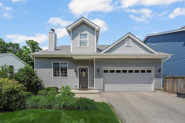 228 Juneway Ter, Lake Bluff, IL 60044 - view of front facade featuring asphalt driveway, a garage, and a chimney