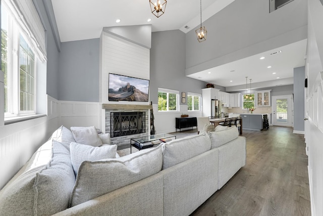 228 Juneway Ter, Lake Bluff, IL 60044 - living area with a fireplace, plenty of natural light, wood finished floors, high vaulted ceiling, and recessed lighting