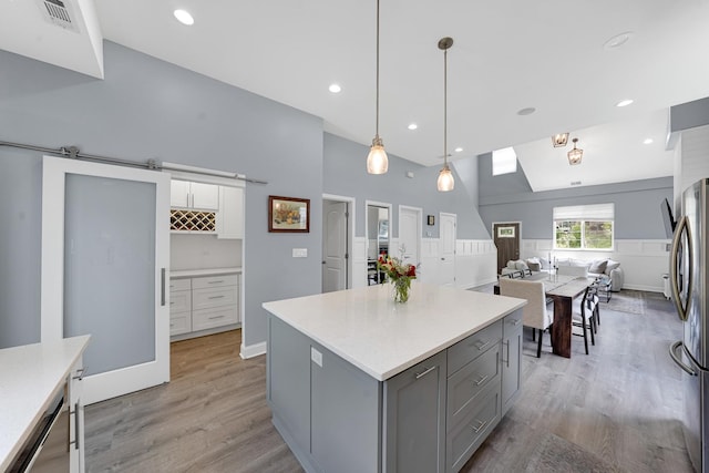 228 Juneway Ter, Lake Bluff, IL 60044 - kitchen with gray cabinetry, light wood finished floors, open floor plan, light countertops, and white cabinets