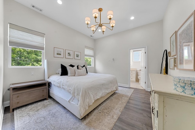 228 Juneway Ter, Lake Bluff, IL 60044 - bedroom with a chandelier, multiple windows, wood finished floors, recessed lighting, and ensuite bath