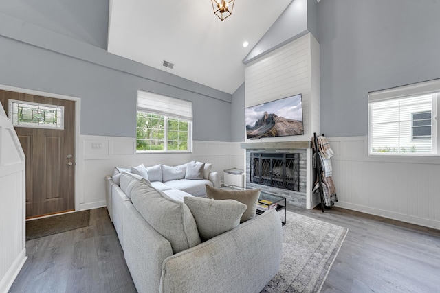 228 Juneway Ter, Lake Bluff, IL 60044 - living area featuring high vaulted ceiling, a wainscoted wall, wood finished floors, and a fireplace