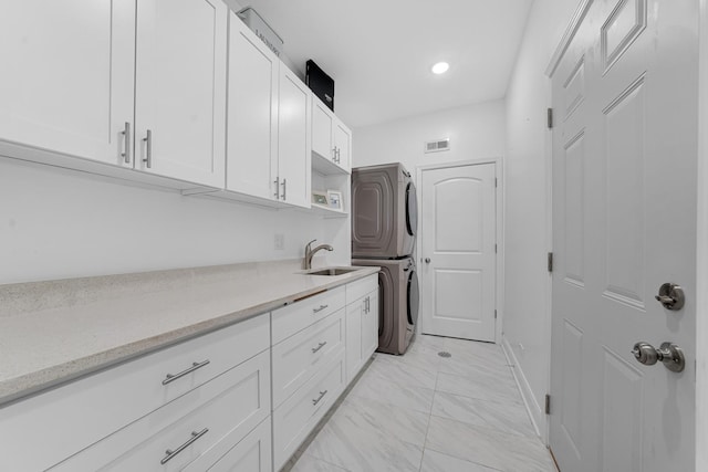 228 Juneway Ter, Lake Bluff, IL 60044 - laundry room with stacked washing machine and dryer, cabinet space, light marble finish flooring, and recessed lighting