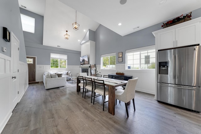 228 Juneway Ter, Lake Bluff, IL 60044 - dining space with high vaulted ceiling, wainscoting, light wood finished floors, and recessed lighting