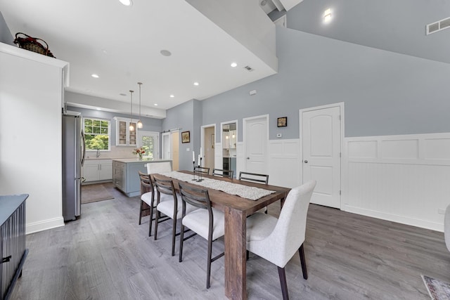 228 Juneway Ter, Lake Bluff, IL 60044 - dining space with wood finished floors, recessed lighting, a wainscoted wall, a decorative wall, and a towering ceiling