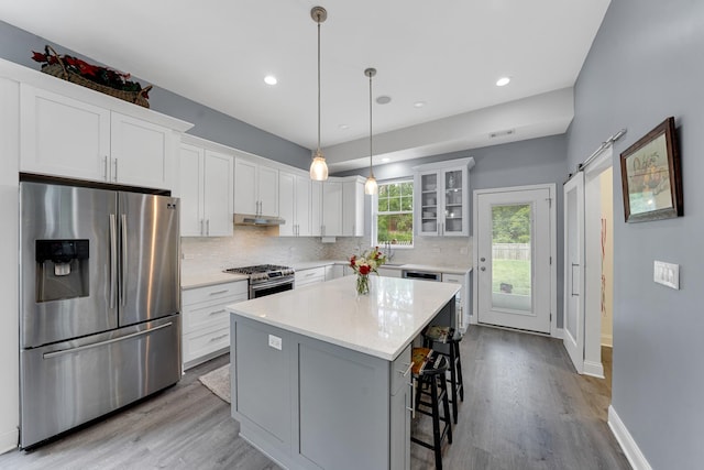 228 Juneway Ter, Lake Bluff, IL 60044 - kitchen with stainless steel appliances, wood finished floors, backsplash, white cabinetry, and recessed lighting